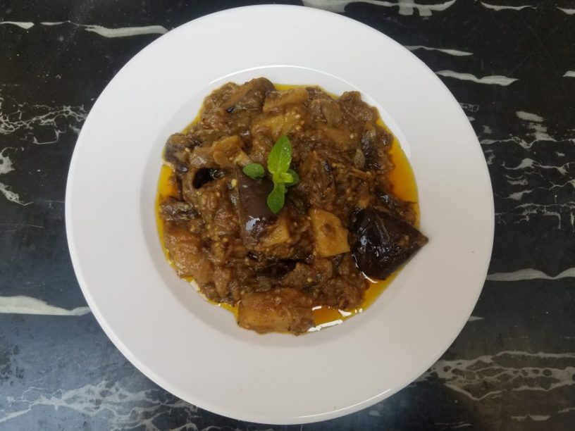 Baingan Aaloo (brinjal or eggplant and Potatoes) Baingan(brinjal or eggplant) is a vegetable of dark purple color and is known with different names in different parts of the world. In South Asia and South Africa it is called brinjal, in Europe, Australia and Newziland it is called eggplant. The French call it aborigine. There are at least 10 ways to cook baingan (brinjal, eggplant). Here we are presenting a very simple, delicious and mouthwatering recipe to cook baingan (brinjal, eggplant). Ingredients ½ Kg Baingan (brinjal, eggplant) ¼ kg potatoes (peeled and chopped in cubes) 2 onions chopped finelly 1 tomatoes chopped in cubes 2 large size green chillis (finally chopped) 1 teaspoon salt 1 teaspoon red chili powder ¼ teaspoon turmeric powder Ghee or oil ½ cup 1 cup of water Method Wash the baingans (brinjals, eggplant) Cut the baigan (brinjal, eggplant) length wise in thin slices In a cooking pan put the ½ cup of ghee and put it on medium flame; Add chopped onions and keep stirring so that the onions do not burn; When the onions are light brown add chopped tomatoes and green chilies; Then add salt, red chili and turmeric; Keep stirring until the tomatoes are mashed and everything is mixed; Lower the heat to the minimum, add fried baingan (brinjal, eggplant) and sauté for five minutes, Now add chopped potatoes and sauté for 3 minutes; Now add 1 cup of water and lower the flame to minimum; Cover it with a lid and after ten minutes check if the potatoes are soft; when the potatoes are soft see if there is extra water then evaporate it on high flame; Very delicious and tasty baingan (brinjal, eggplant) is ready to serve. Serve it with roti or boiled rice.