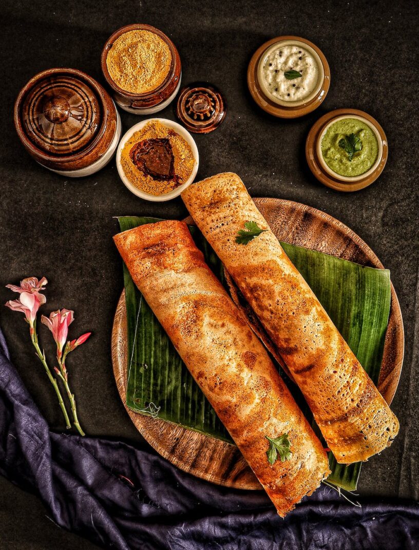 a pair of tosei on a wooden tray with banana leaf