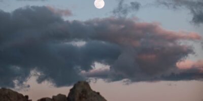 photo of full moon on a twilight sky